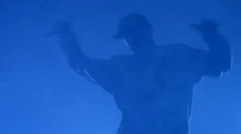 Boy dancing in a smoke on a blue background Stock Footage 63084633