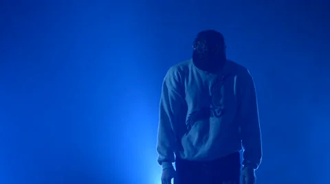 Boy dancing in a smoke on a blue background Stock Footage 63084860