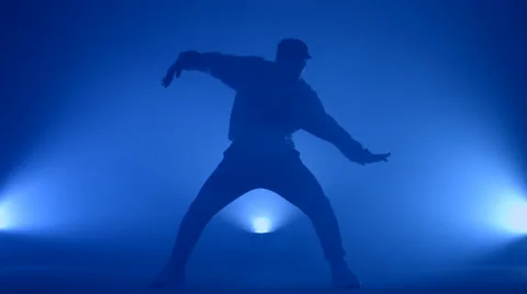 Boy dancing in a smoke on a blue background Stock Footage 63086541