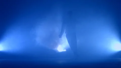 Boy dancing in a smoke on a blue background Stock Footage 63087726