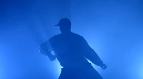 Boy dancing in a smoke on a blue background Stock Footage 63089258