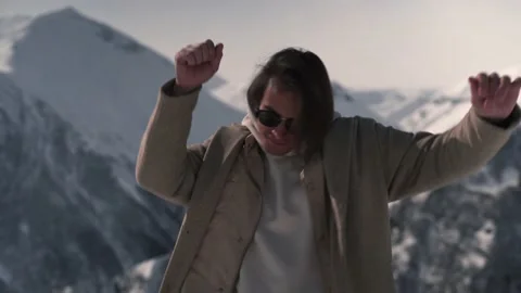 The boy is dancing in the snowy mountains Stock Footage 169814718