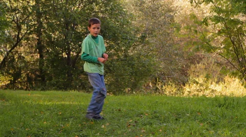 Boy dancing, somersaults, jumping on the grass Video stock 28861333