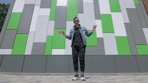 Boy dancing street modern dance on an open stage in public park. Slow motion Stock Footage 132659593