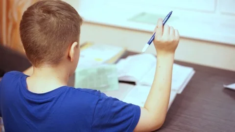 The boy is dancing at the table. He is bored of sitting at the table and doing s Stock Footage 99468241