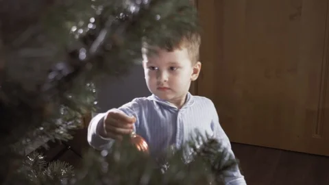 Boy decorate a Christmas tree Stock Footage 113753047