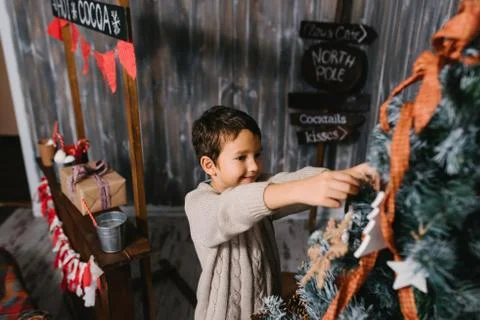 Boy decorates Christmas tree Stock Photos