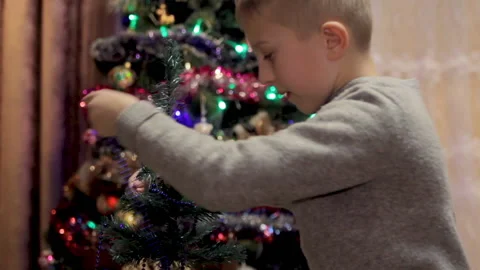 Boy decorates Christmas trees Stock Footage 142961122
