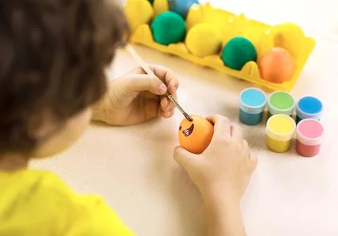 Boy decorates Easter egg, close-up Stock Photos