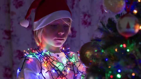Boy decorating Christmas tree at home Stock Footage 219019934