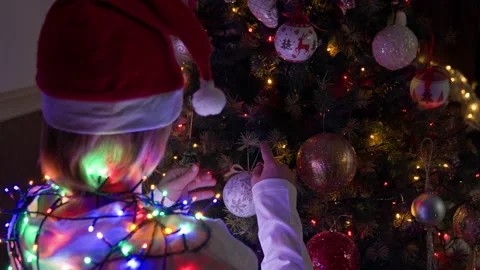 Boy decorating Christmas tree at home Stock Footage 219284271