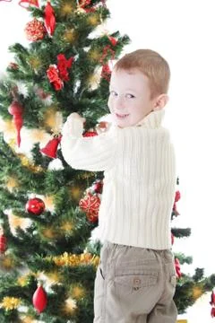Boy decorating Christmas tree Stock Photos