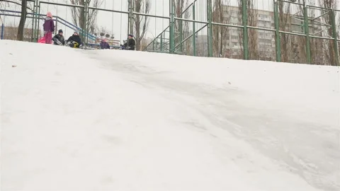 Boy descends on his back from a snow slide. Slow motion Stock Footage 126347960