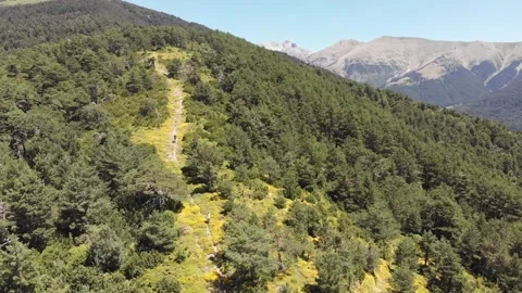Boy descends a mountain path with his parents 動画素材 144521614