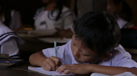 Boy at Desk takes Notes in School 스톡 동영상 37350226