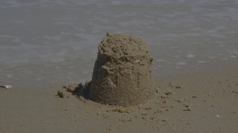 Boy Destorying Small Sandcastle on the Beach Video stock 74368178