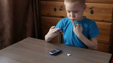 Boy diabetic measures blood glucose level of blood sugar #1 Stock Footage