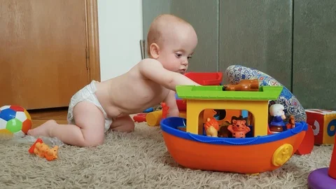 The boy in the diaper plays on the floor Stock Footage 91862676