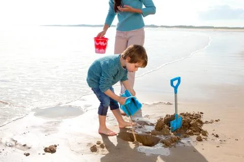 Boy Digging on the Beach 스톡 사진
