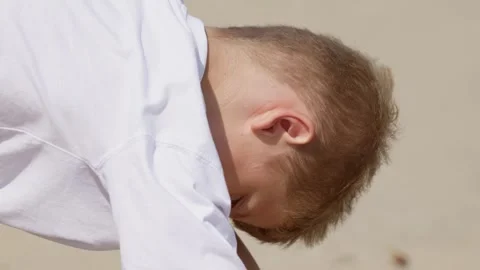 A Boy is Digging in the Sand Close Up Slow Motion Video stock 347585101