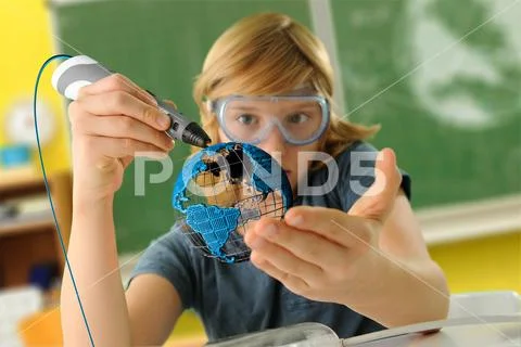 Boy with digital pen and 3D model of globe in classroom Stock Photos