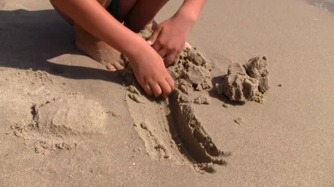 A boy Digs A Hole On The Sandy Beach Stock Footage 301521430