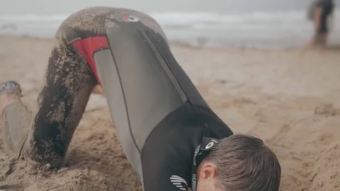 Boy Digs a Sand Hole on a Beach Stock Footage 79644874