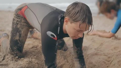 Boy Digs a Sand Hole on a Beach Stock Photos