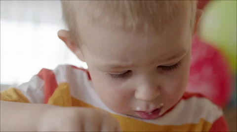 Boy with Dirty Face Having a Bite Stock Footage 60388625