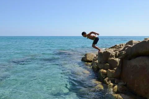 Boy dive into the sea Stock Photos