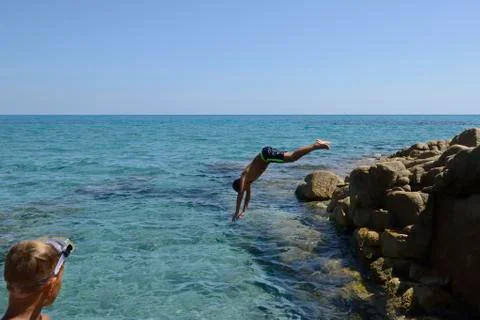 Boy dive into the sea Stock Photos