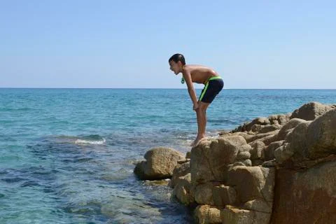 Boy dive into the sea Stock Photos