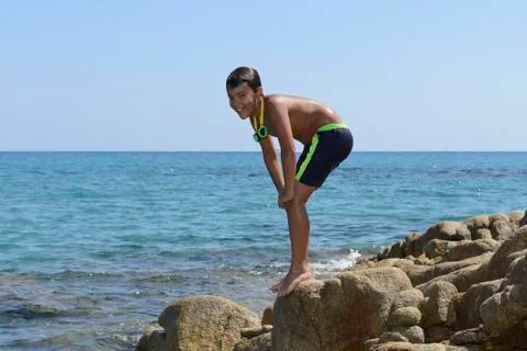 Boy dive into the sea Stock Photos