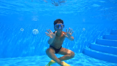 Boy dive in swimming pool Stock Footage 114996081