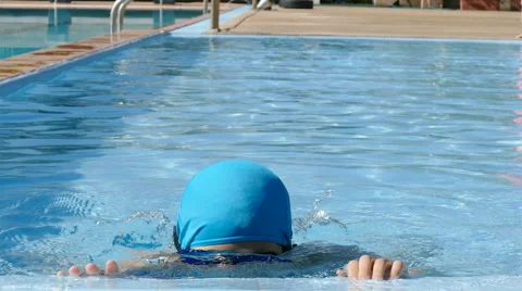 Boy dives in blue pool Stock Footage 58808963