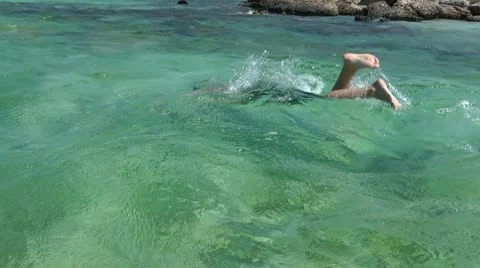 Boy dives in the lagoon Stock Footage 8976254