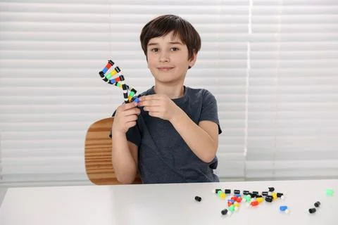 Boy with DNA structure model at desk indoors 写真素材