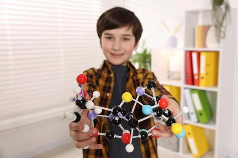 Boy with DNA structure model indoors, selective focus 스톡 사진