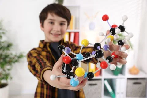Boy with DNA structure model indoors, selective focus 스톡 사진