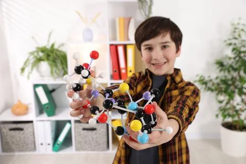 Boy with DNA structure model indoors, selective focus 스톡 사진