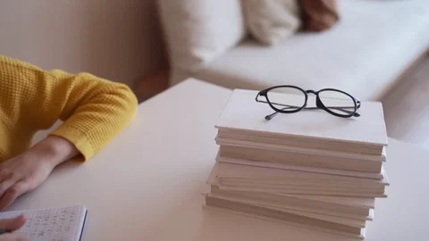 Boy do school homework, writes a ballpoint pen in a notebook. Stock Footage 104240180