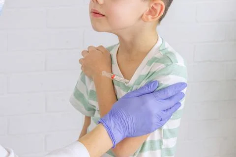 Boy at doctor's appointment taking temperature. Pediatrician's appointment, h Stock Photos