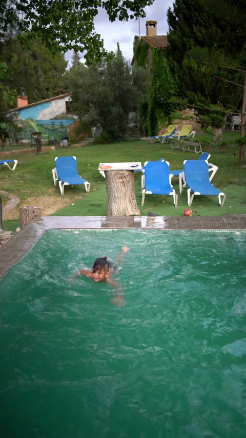 Boy Does a Flip Into a Backyard Pool at a Country House Stock Footage 345043590