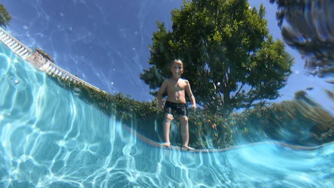 Boy Does Flip Into Pool Stockbeeldmateriaal 129731840
