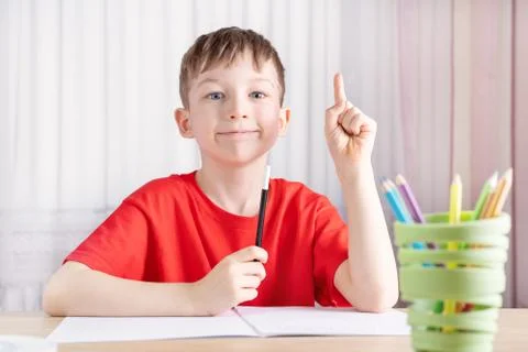 The boy does his homework and he has an idea Stock Photos