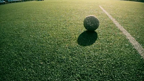 Boy does hit the ball on the green football field on a Sunny day, slowmotion. Stock Footage 108900794