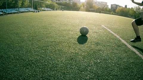 Boy does hit the ball on the green football field on a Sunny day, slowmotion 스톡 동영상 109472334