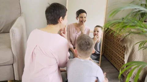 Boy does logopedic exercises opposite mirror at home Stock Footage 150088085