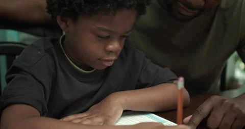 Boy does math homework with Father Video stock 131685392