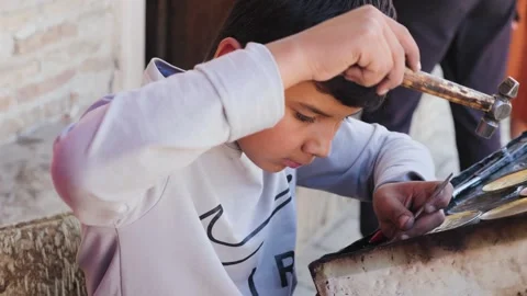 A boy does metal work Stock Footage 258468189